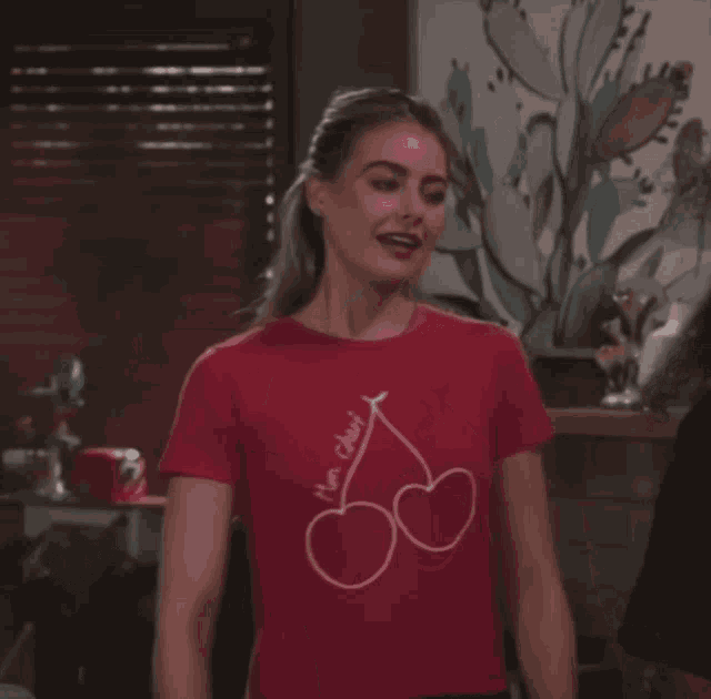 a woman wearing a red t-shirt that says mon cheri