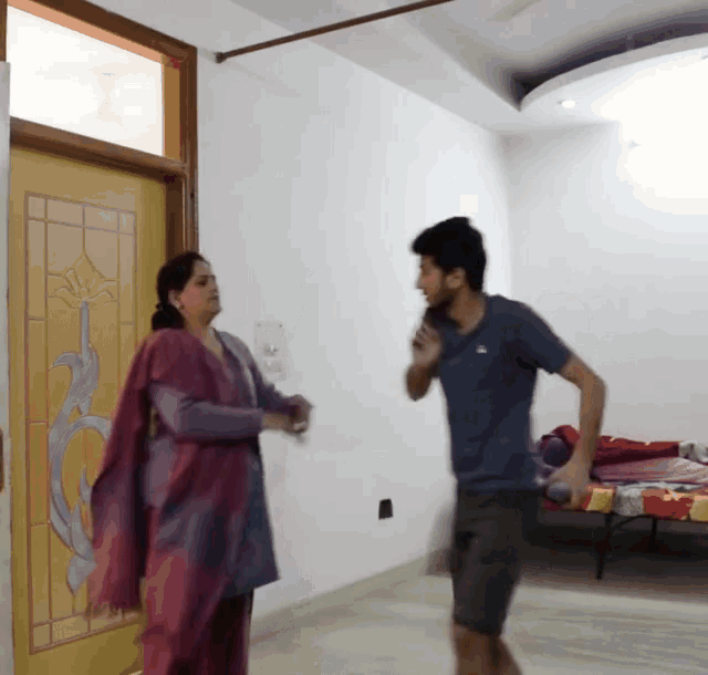 a man and a woman are standing in front of a door