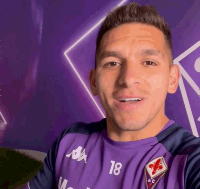 a man wearing a purple shirt with the number 18