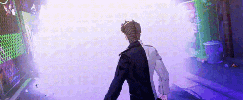 a man in a black and white suit is walking through a purple tunnel .