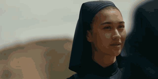 a woman wearing a head scarf and a black shirt