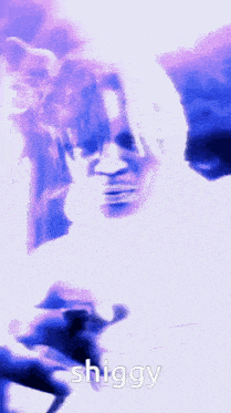 a person is singing into a microphone and the word shiggy is on the bottom of the image .