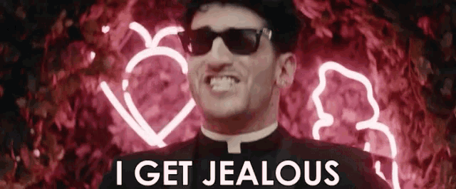 a man in a tuxedo and sunglasses is smiling and says i get jealous
