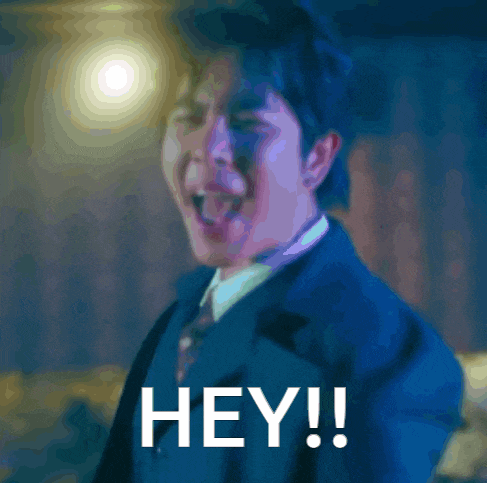 a man in a suit and tie says hey in white letters
