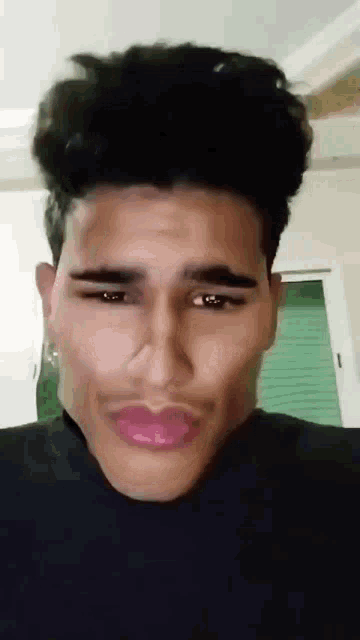 a close up of a man 's face with a fake mustache and pink lips .