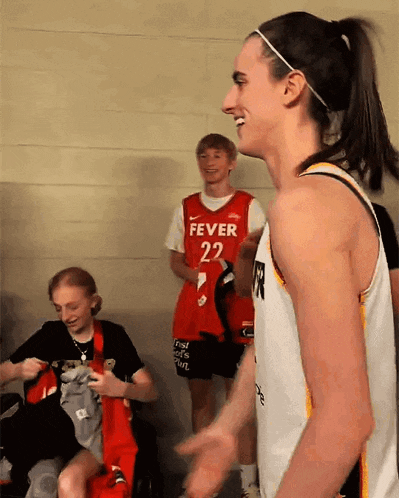a female basketball player wearing a fever 22 jersey
