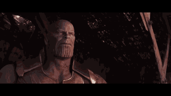 a close up of thanos ' face with a beard in a dark room
