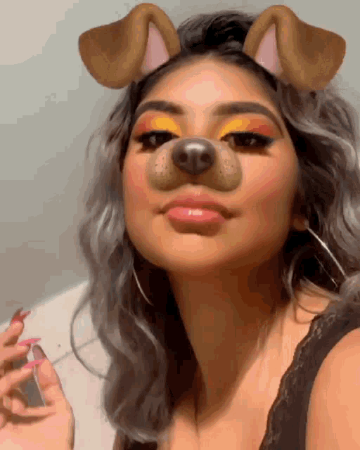a woman is wearing a dog ear filter on her face