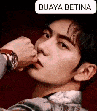 a close up of a man 's face with the words buaya betina on the bottom