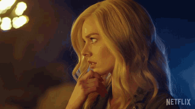 a close up of a woman 's face with netflix written on the bottom right