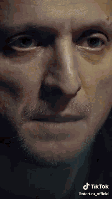 a close up of a man 's face with a tiktok logo