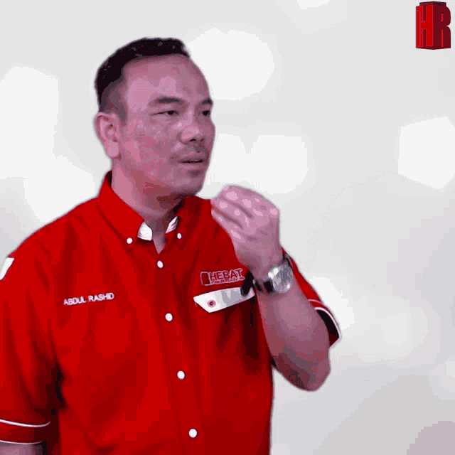 a man wearing a red shirt that says abdul rashid