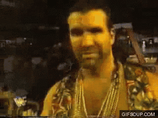 a pixelated image of a man with a beard and a necklace with gifsoup.com at the bottom