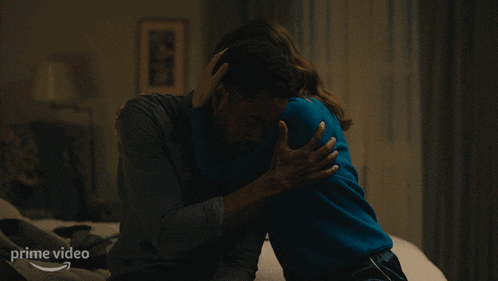 a man and a woman hugging with a prime video logo in the background