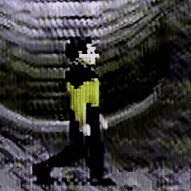 a pixelated image of a person in a yellow shirt and black pants