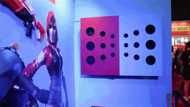 a wall with a red hooded figure and a sign that says comics