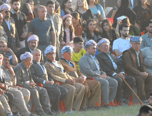 a group of people sitting in a field with a photo taken on march 5th 2015