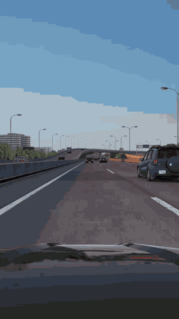 a blue car is driving down a highway with a white line on the right