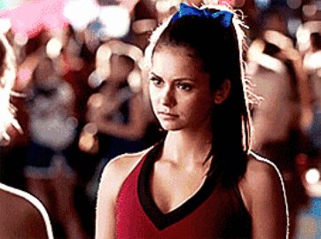 a cheerleader wearing a blue bow in her hair