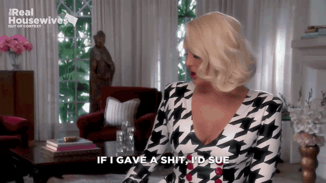a woman in a houndstooth dress says if i gave a shit id sue