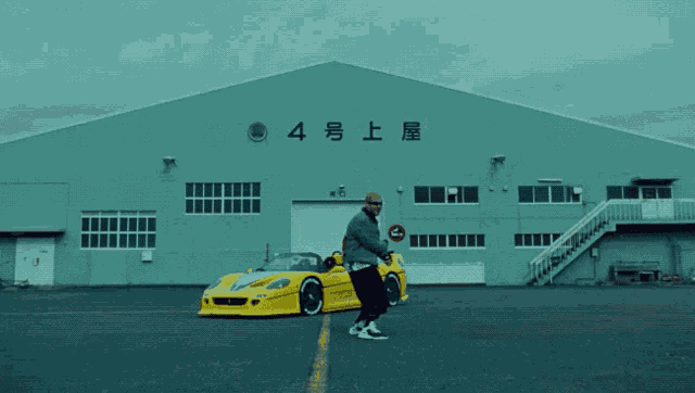 a man standing in front of a building that says 4 on it