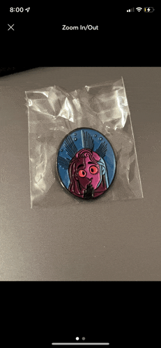 a phone screen shows a picture of a pin that says zoom in/out