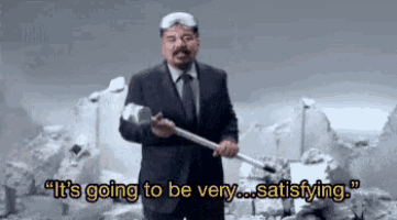 a man in a suit is holding a hammer and saying it 's going to be very satisfying