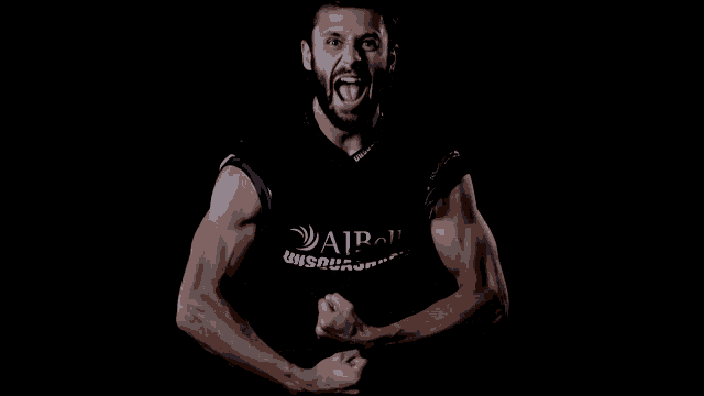 a man flexing his muscles wearing a black shirt that says aipol