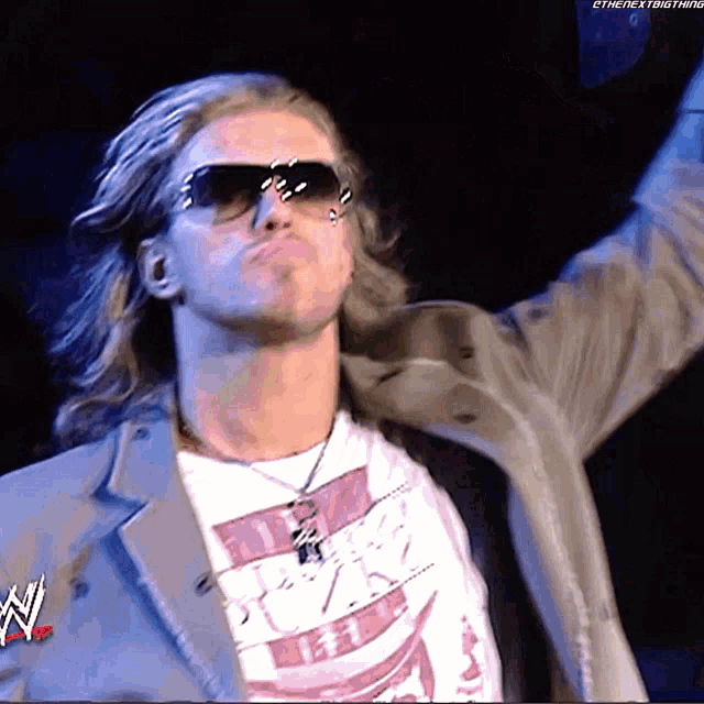 a man wearing sunglasses and a t-shirt that says ' tna ' on it