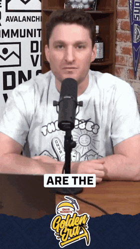 a man sitting in front of a microphone with the words are the golden nuggets