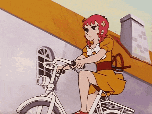 a girl in a yellow dress is riding a bike