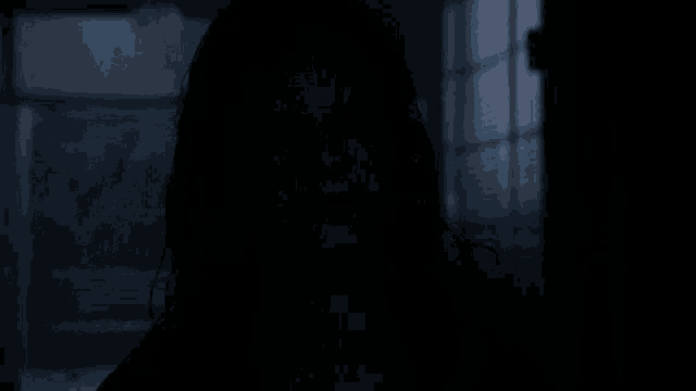 a woman with a scary face and black eyes