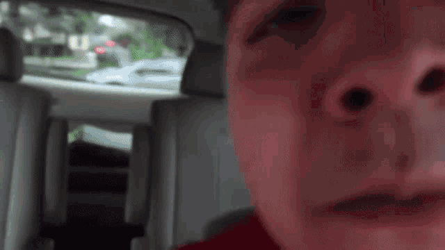 a close up of a person 's face with a red nose