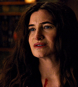 a close up of a woman with blood on her neck