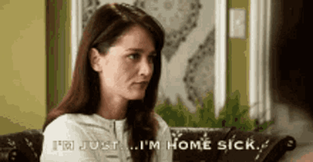 a woman is sitting on a couch and saying i 'm just ... i 'm home sick