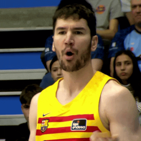 a man wearing a yellow tank top with a red and white stripe and the word endesa on it
