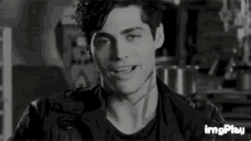 a black and white photo of a young man in a leather jacket .