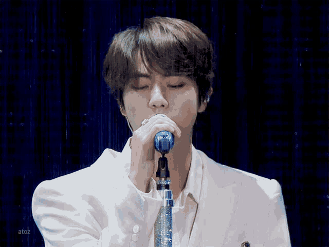 a close up of a person singing into a microphone with alto2 written on the bottom right