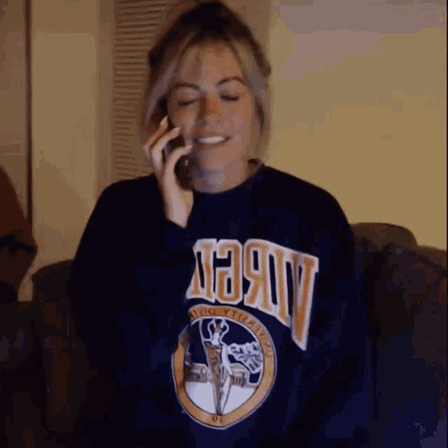 a woman wearing a sweatshirt that says ' avery ' on it