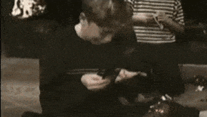 a boy is sitting on the floor with his mouth open and another boy is sitting on a couch .