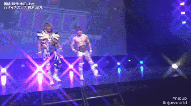 two wrestlers are on a stage with the hashtag #njpwworld