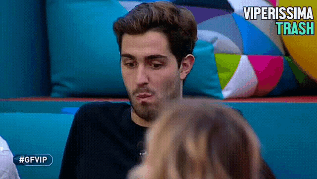 a man sitting on a couch with the words viperissima traci written on the bottom