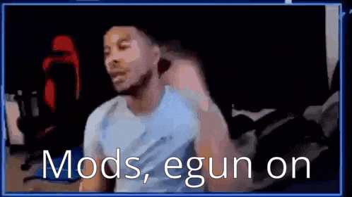 a man is sitting in front of a computer screen with the words `` mods , egun on '' written above him .
