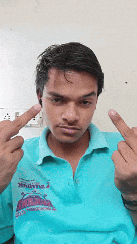 a young man wearing a blue shirt that says ' aa ' on it