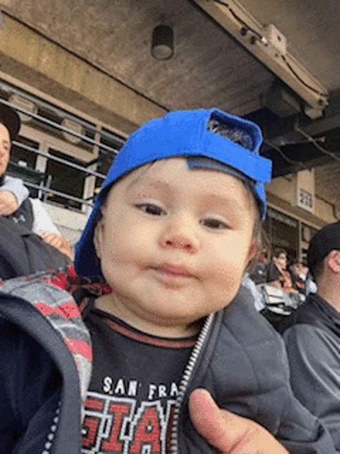 a baby wearing a blue hat and a shirt that says san francisco