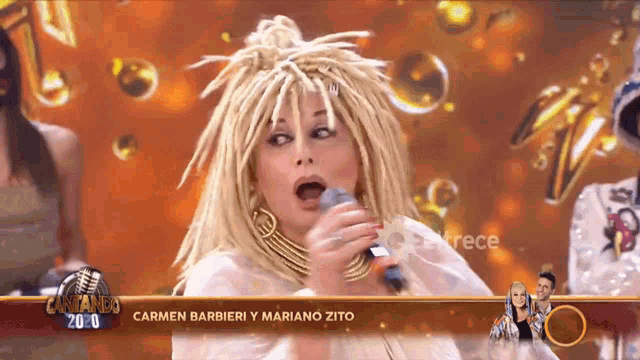 a woman singing into a microphone with the words cantando 2010 on the bottom