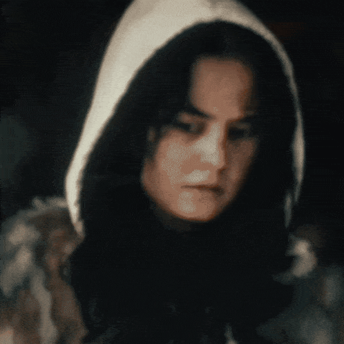 a blurry picture of a woman wearing a hood