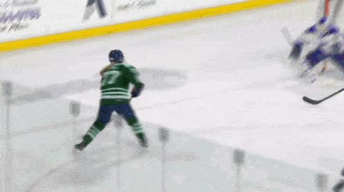 a hockey game is being played in front of a sign that says tscout