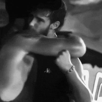 two men are hugging each other in a black and white photo .