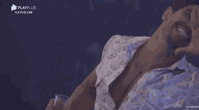 a man is laying down with his mouth open and a playplus logo on the bottom